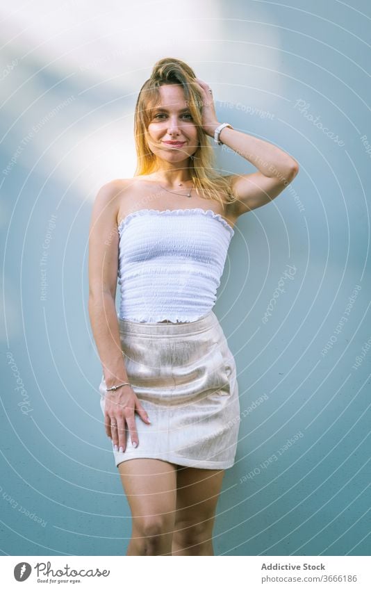 Positive young slim lady in black underwear and denim jacket standing in  studio - a Royalty Free Stock Photo from Photocase