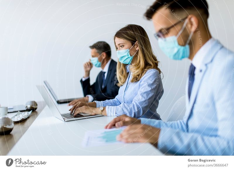 Group of business people have a meeting and working in office and wear masks as protection from corona virus brainstorming businessman businesswoman care