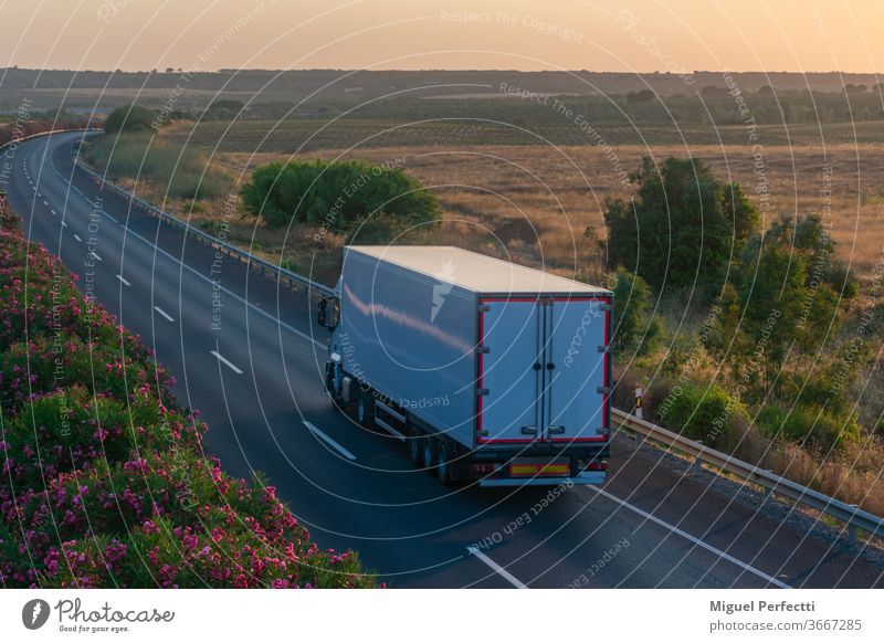 Truck with refrigerated semi-trailer driving on the highway truck road transportation perishable fruit transport controlled temperature cargo travel traffic