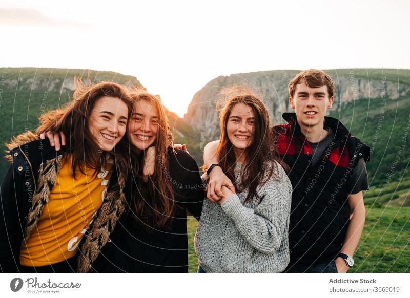 Company of friends together in highlands mountain spectacular friendship hug vacation group sunset transylvania romania saint george happy smile embrace joy