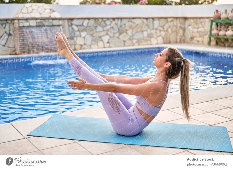 Fit woman on a mat at ocean. Slim female relaxing after yoga