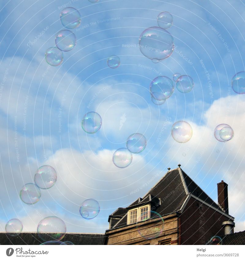 many soap bubbles in front of a blue sky with clouds, in the background a building Sky Clouds built Architecture House (Residential Structure) Ease Flying