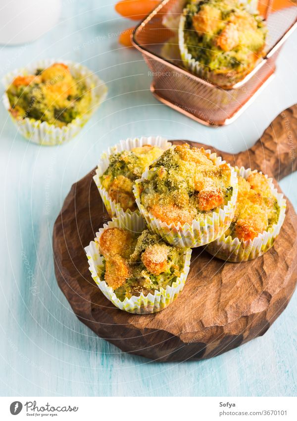 Healthy vegetable muffins with carrot and broccoli homemade healthy wooden board serve corn breading kids children colorful recipe easy cake diet food green