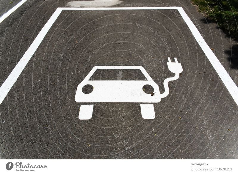 Pictogram marked parking place for electric cars Parking lot pictogram Street Parking space identification Traffic infrastructure Asphalt Signs and labeling