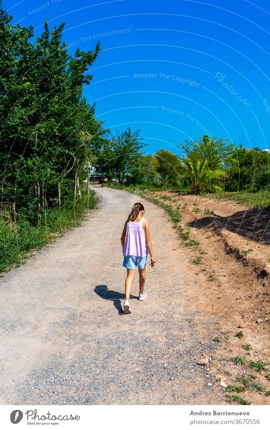 Small girl walking on a stone path in an environment surrounded by natured hill exercise healthy man training mountain workout summertime trekking sunlight calf