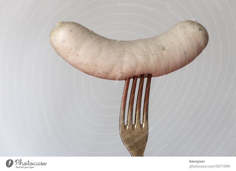 Bavarian veal sausage on white background Veal sausage segregated Silver Fork Individual White Meat traditionally Meal Eating Munich cake Oktoberfest Breakfast