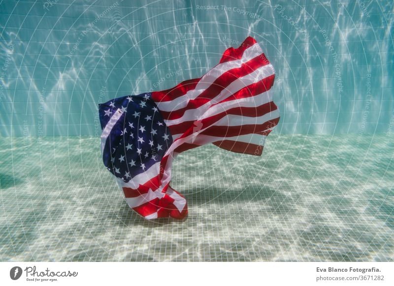 american flag underwater in a pool. 4th july concept, independence day. Nobody fourth july united states swimming pool summer ripple us country signs star wave
