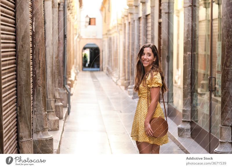 Charming woman walking along street city stroll enjoy weekend content summer charming female happy style trendy smile young urban delight positive lady glad