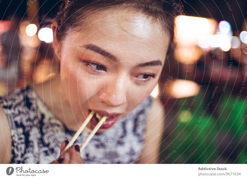 Asian woman eating rice in Zhubei Night Market glutinous oil rice dish oriental zhubei night market delicious tradition street food chopstick female taiwan