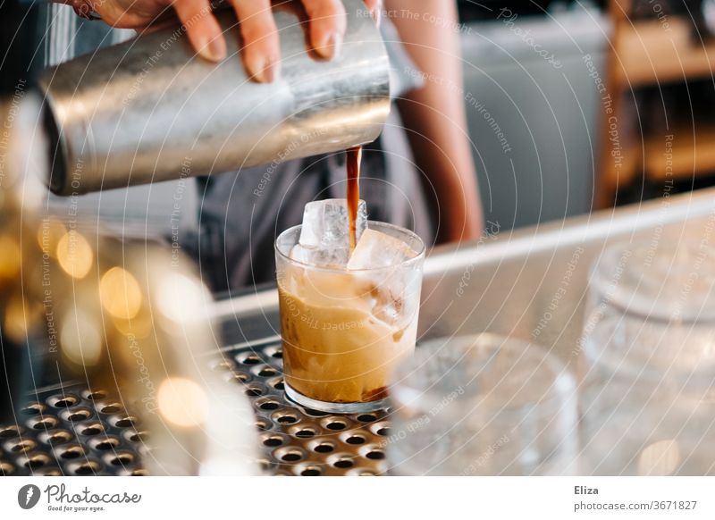 Preparation of a cold mixed coffee on ice Coffee chill Iced coffee shaked Caffé Freddo Bear Café Gastronomy Beverage Summer Caffeine Shakerato Cast shaker Glass