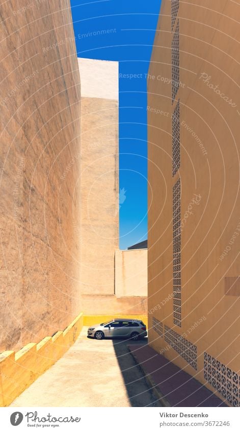 The car is parked on a summer day among the buildings spain tall hot house architecture city town street sky outdoor transport europe urban view blue travel