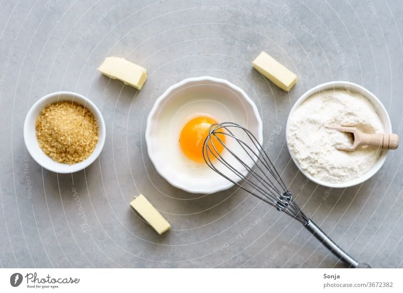 Egg yolks, flour and sugar in three white bowls. Baking ingredients for cakes, top view. Ingredients Flour Sugar Table Cake Rustic Dough Food Whisk Butter