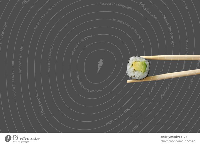 fresh vegetarian maki sushi roll with wooden chopsticks isolated on grey background. copy space food shrimp sea bass sashimi wasabi salmon avocado tasty asia