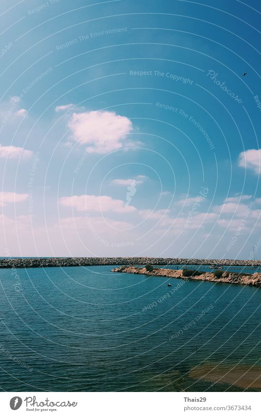 sea side view, dark deep blue water no waves, blue sky sunny day, Tel Aviv, Israel panoramic cloudscape aqua vacation surface texture mediterranean calm ocean