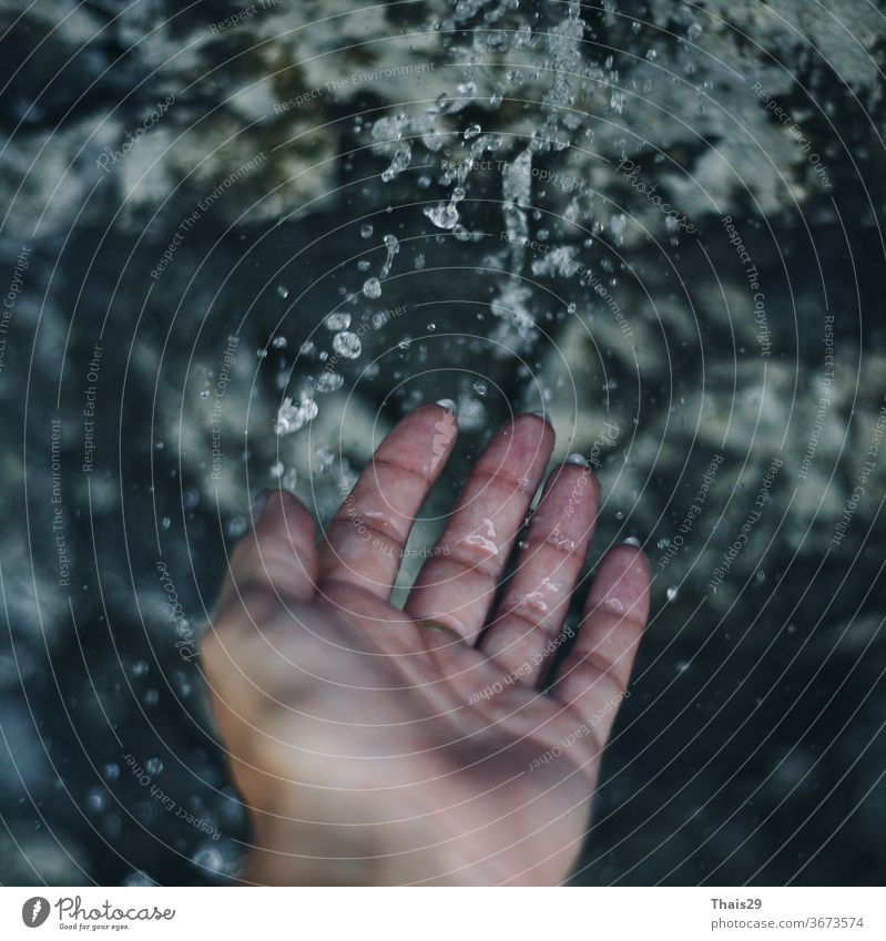 female woman holding hand under the water, washing hands, clean cold falling water, water drops ecology waterfall drink flowing close clear spatter cleanse