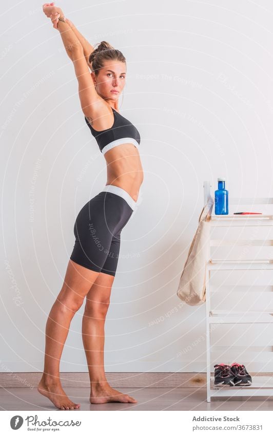 Woman stretching arms for good flexibility of her bicep stock