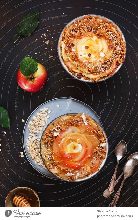 Apple cinnamon oatmeal. Sweet apples with a crunchy, crumbly cinnamon and honey topping art background bowl bran brown cereal dairy dark dessert diet dieting