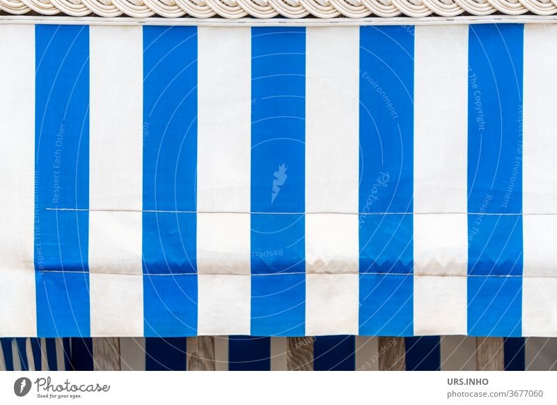 the blue and white striped sunshade on the empty beach chair hides the view Beach chair rental sun protection decorations Striped Sunshield White Blue