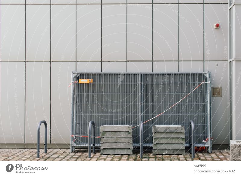 barricaded wire mesh on an external facade Protective Grating Hoarding Metalware cordon lattice fence Safety Fences Abstract flutterband gray wall Facade Line
