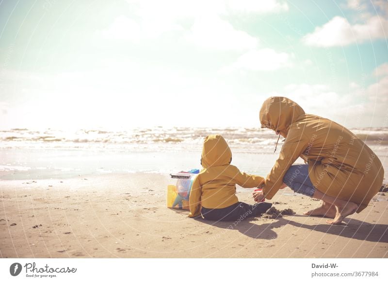 Mother and child with Frisian mink playing together on the beach friesennerz Child Son Mother with child Mother with son Playing Beach atmospheric Sunlight