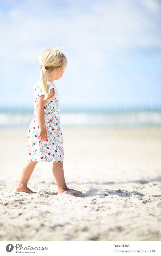 a young girl goes for a walk on the beach in perfect weather Child stroll To go for a walk Beach vacation Vacation & Travel Exterior shot Colour photo Ocean