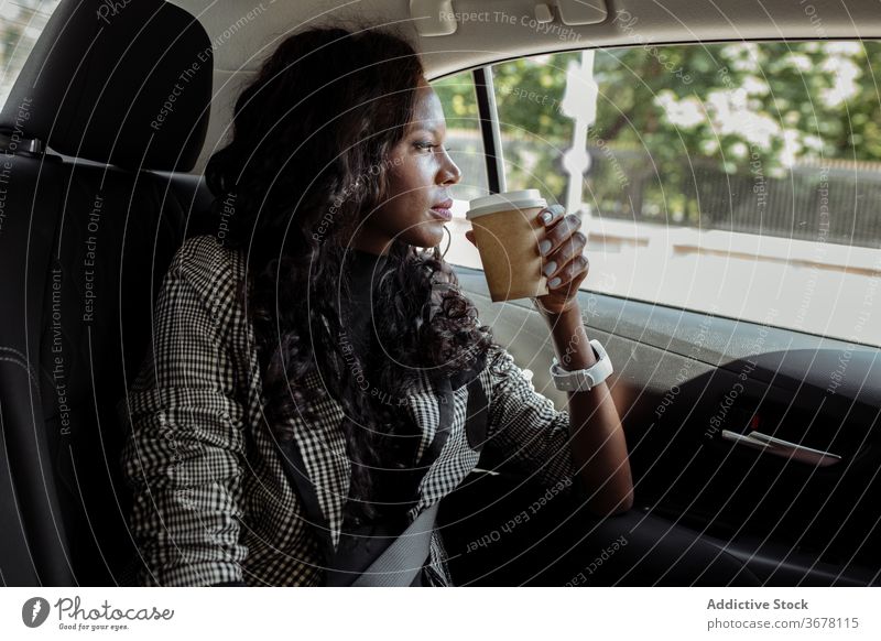 Pensive businesswoman with cup of coffee sitting in car drink pensive think busy modern serious young african american black ethnic trip takeaway to go beverage