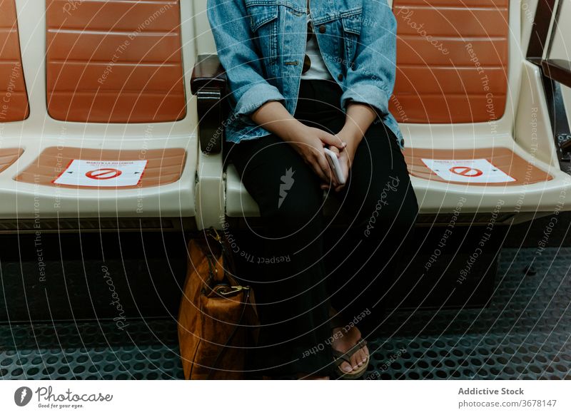 Woman sitting in subway wagon with marking for keeping distance coronavirus metro passenger woman social distancing covid pandemic restriction infection female