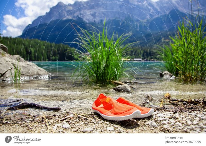 Bathing shoes at the Eibsee shore in the Bavarian Alps near Garmisch Partenkirchen, Bavaria Germany. View of the Wetterstein mountain range. Wetterstein mountain range Zugspitze
