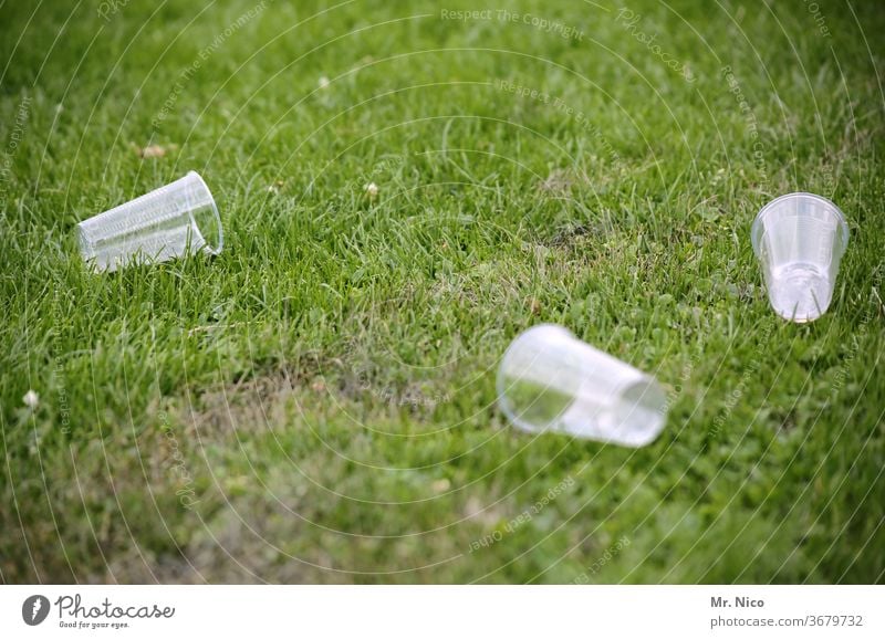 empty plastic cups lie in the grass Mug Trash Environmental pollution Plastic Recycling Packaging waste Meadow Lawn Grass Disposal Plastic cup Throw away Park