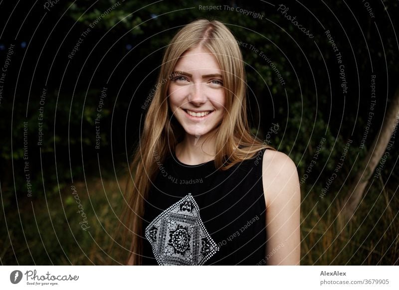 Portrait of a young woman in nature in front of a forest Purity luck Beautiful weather Trip Expectation Sunlight Close-up Day Looking into the camera