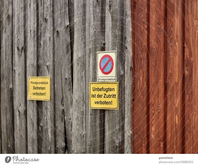 No entry signs on a barn door. Faded wood. Private property Signs Bans No trespassing Private way Barn door Signs and labeling Signage Warning sign Characters