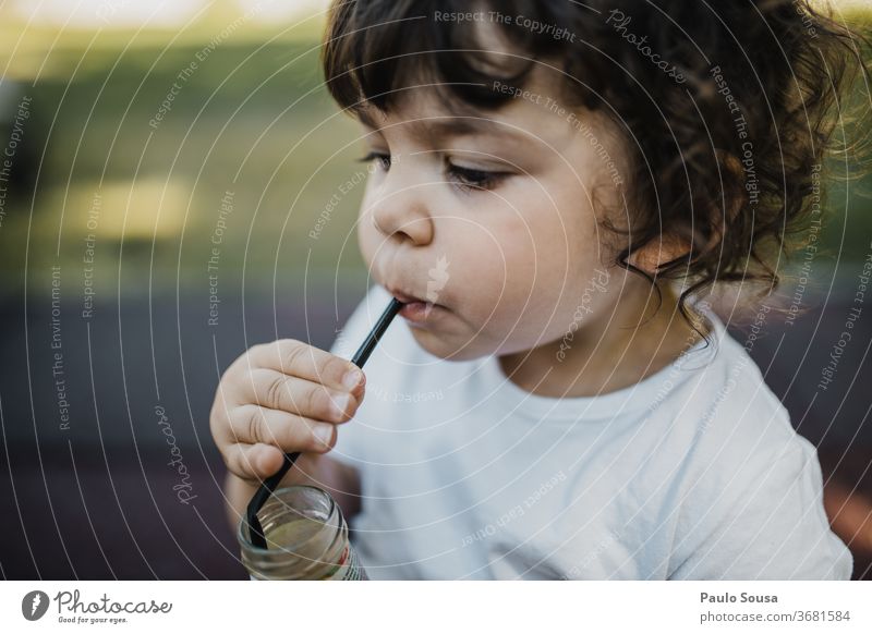 Child drinking Juice from straw Straw Nature Yellow childhood Drinking Juice glass Fresh Healthy Lemonade Colour photo Beverage Cold drink Fruit Delicious Food