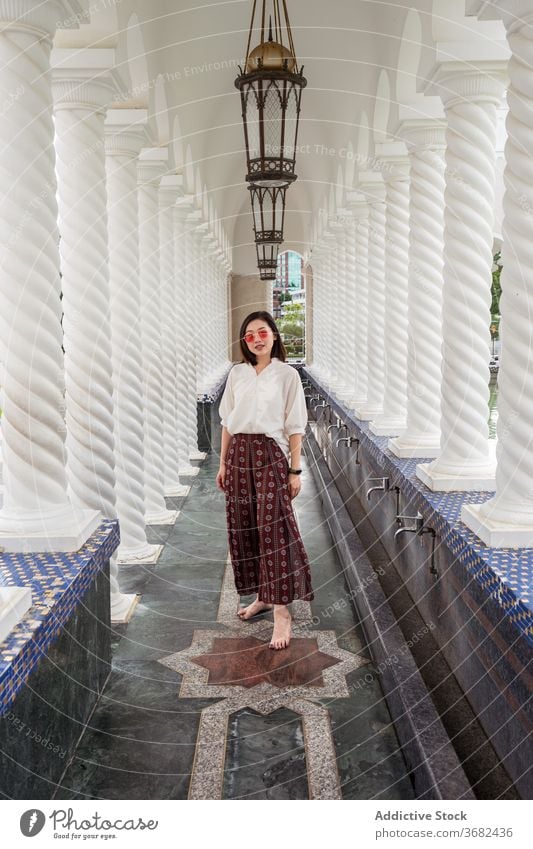 Asian woman in arched passage of Omar Ali Saifuddien Mosque omar ali saifuddien mosque travel landmark tourist city female asian ethnic bandar seri begawan