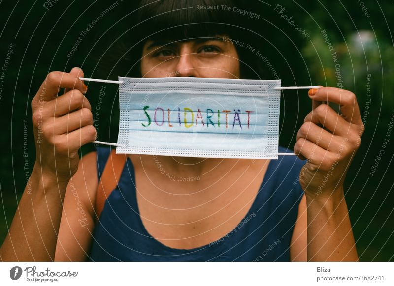 A mouthguard on which the word solidarity is written in colourful letters. Pro Mask duty and masks wear to protect everyone during the Corona pandemic.