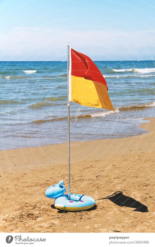 Flag on the beach with swim ring Beach Ocean Sand Water Waves Sun Sky Coast Summer Vacation & Travel Blue Tourism Summer vacation Beautiful weather Deserted