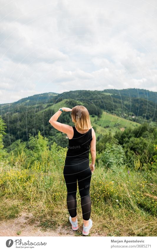 Young woman enjoying the view of a beautiful mountain range adventure destination explore explorer exploring female forest free freedom girl healthy hike hiker