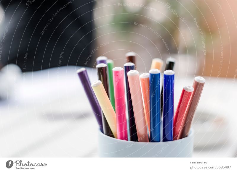 a group of colored markers in a plastic container. pen education equipment object background design art drawing office school blue green pencil basket holder