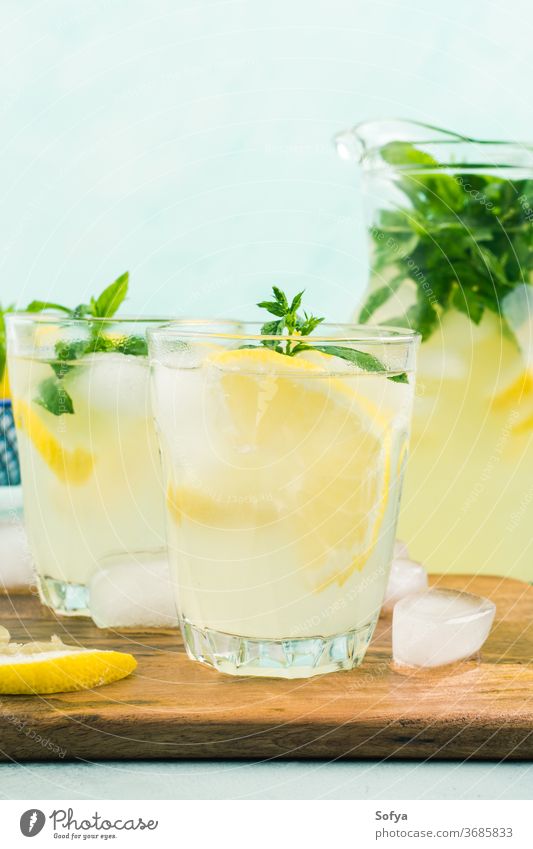 Fresh lemon lemonade in jug and glasses summer italian beverage cocktail drink sweet healthy fruit leaf spring juice citrus mint gin vodka infused alcohol