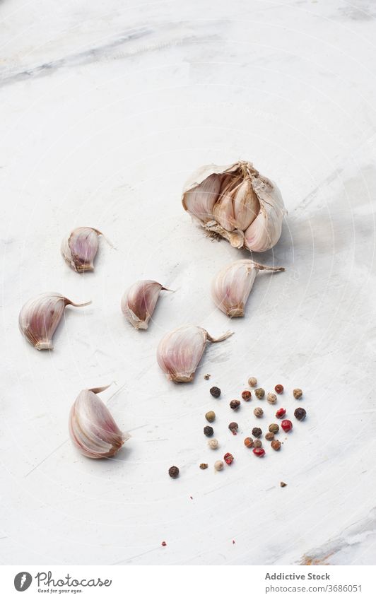 Garlic and pepper grains on table garlic peppercorn spice condiment clove assorted seasoning natural food unpeeled ingredient cuisine seed cook culinary kitchen