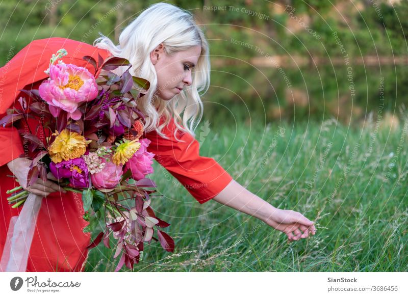 Blonde woman with flowers on the countryside. Portrait photograph Enthusiasm Day Morning Lifestyle Flower Happiness Colour photo Blossom Euphoria Beautiful