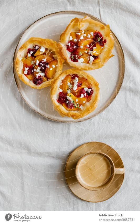 Yummy sweet tarts on cup of coffee pastry baked fruit delicious yummy filo dough aromatic dessert tasty food breakfast homemade morning serve meal nutrition