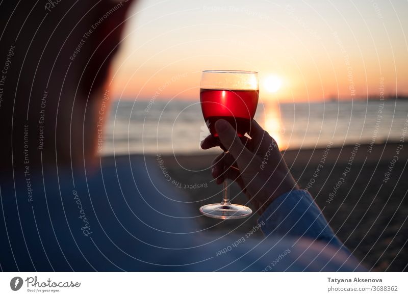 Man with glass of wine on beach at sunset drink alcohol romantic enjoying slow living relax sea beautiful celebration beverage silhouette romance holiday nature