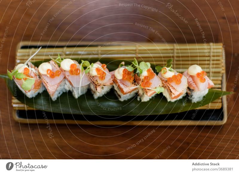 Set of colorful sushi rolls on plate set seafood salmon tasty restaurant luxury serve oriental cheese sauce table fish rice cuisine caviar herb fresh savory