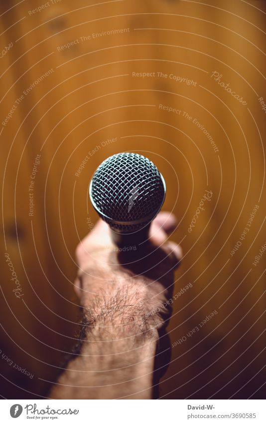Man holds a microphone in his hand ready to speak Microphone Speech present Moderator Business Colour photo Interior shot To talk Communicate Event Speaker