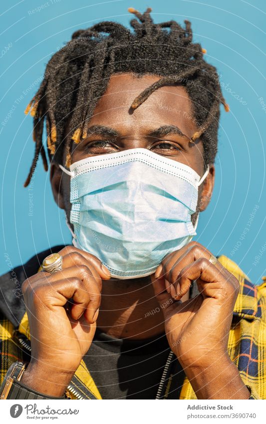 vertical closeup of black man with protective mask person portrait close-up african protection disease virus male epidemic flu health face coronavirus medical