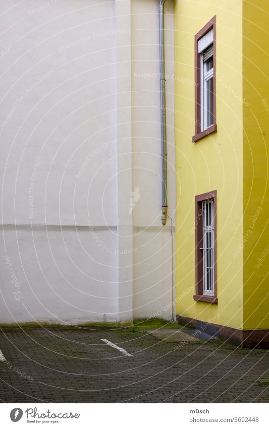 yellow house in an angle Yellow House (Residential Structure) Wall (building) White Window Brown Street Gray Classification Drainpipe Corner angles Light high