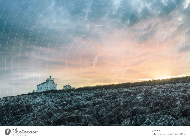 Small house with lighthouse in front of sky at sunset Lighthouse Landscape Idyll tranquillity Horizon Ocean House (Residential Structure) Sky Orange