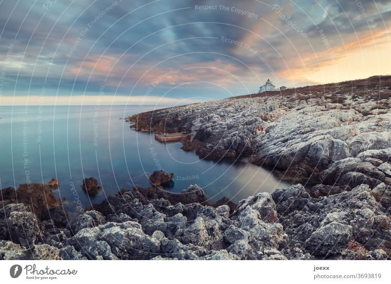 Small lighthouse house, on rocky coast Horizon Sky Rocky coastline Sunset Ocean House (Residential Structure) Lighthouse Landscape Idyll tranquillity