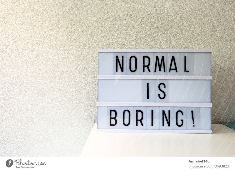 Normal is boring written in Light box home decoration, motivational sign retro home, space for text normal phrase white word concept background quote alphabet