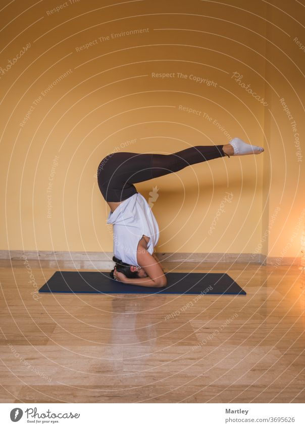 Young woman doing online yoga at home. Online fitness, home